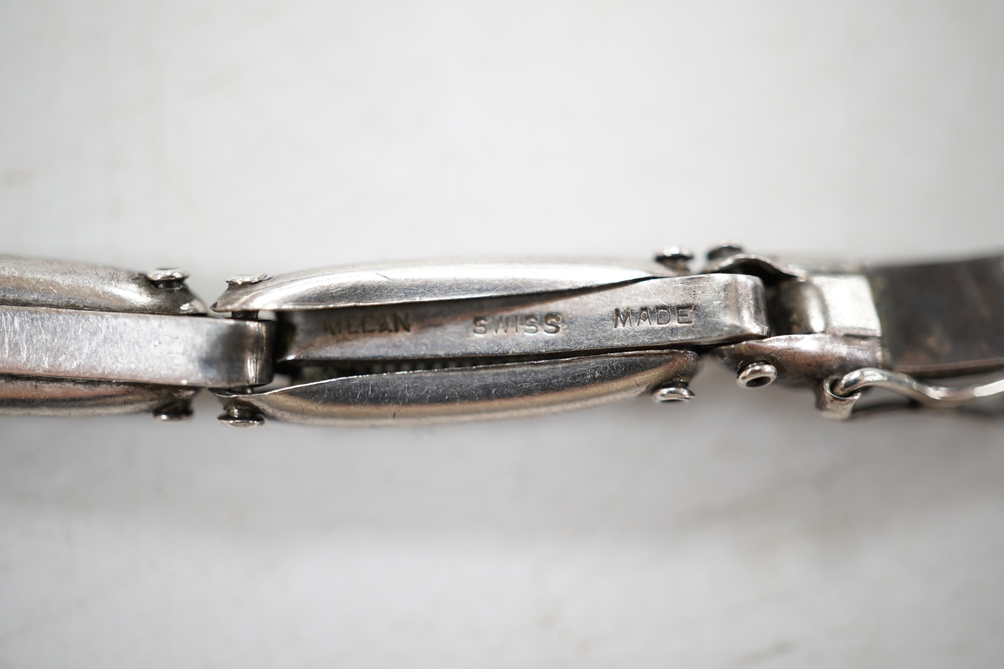 A lady's early 20th century continental sterling and enamel octagonal manual wind wrist watch, on a sterling expanding bracelet, 16.8cm. Condition - poor to fair